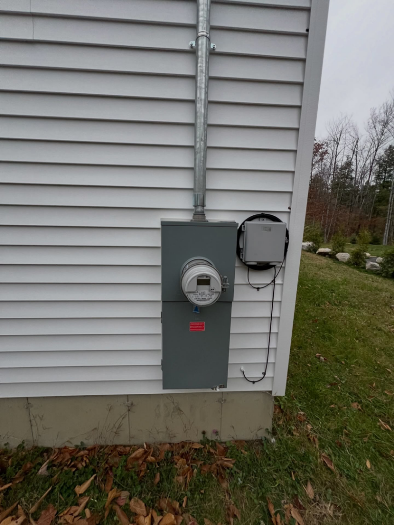 A complete exterior electrical service setup with meter and panel installed by IN Power Electric in Gorham, ME