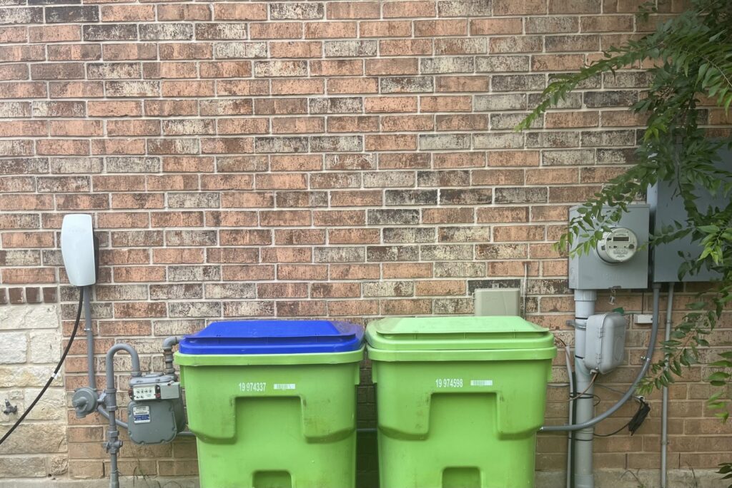The exterior of a house showing a Tesla EV charger and electrical meter, installed by Davis Electric in Cleveland, OH.