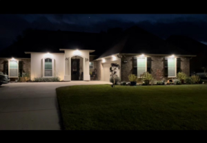 A completed house exterior lighting project, illuminating the facade, by Light of the World Electric in Lake City, FL.
