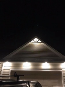 Bright exterior lighting on a house gable and garage installed by Alien Electric Inc. in Dayton, OH.