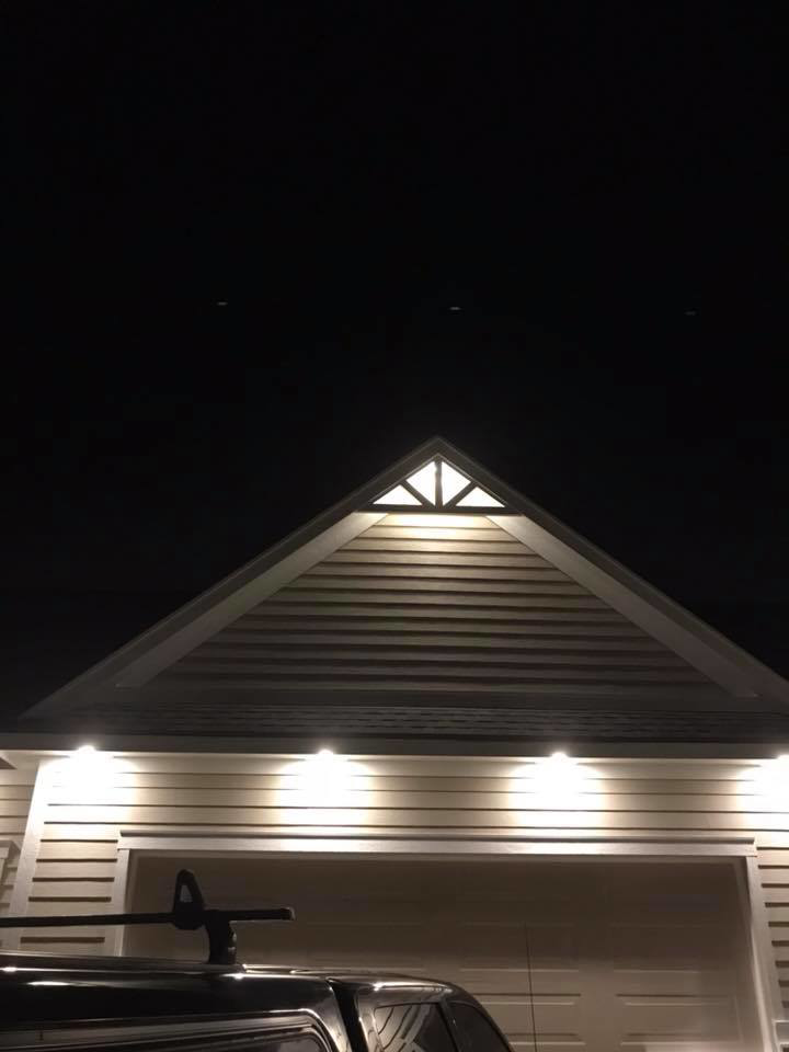 Bright exterior lighting on a house gable and garage installed by Alien Electric Inc. in Dayton, OH.