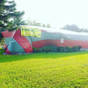 A house under a red and grey tent for termite fumigation by PowerX Pest Control of South Florida in Miami, FL.
