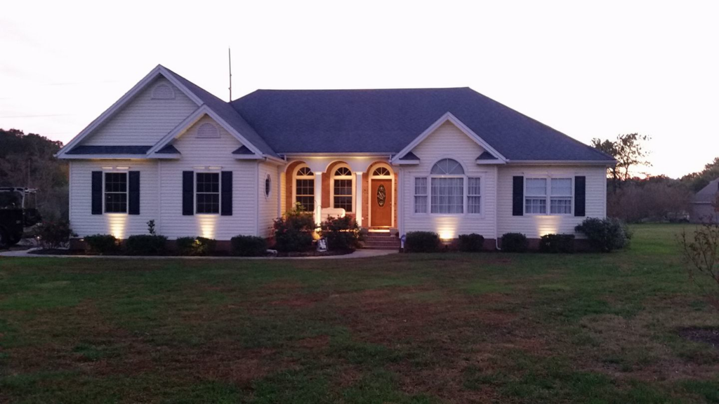 A house showcasing newly installed landscape lighting by KC Electric in Pompton Plains, NJ.