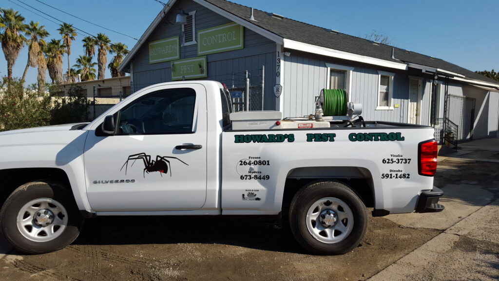 A Howard's Pest Control service vehicle with branding and equipment parked in Fresno, CA.
