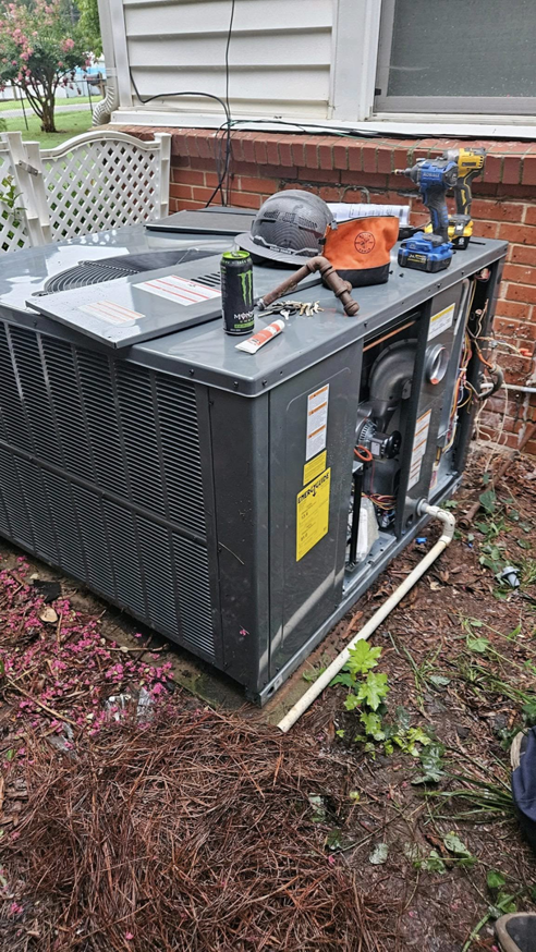 An outdoor AC unit being installed or serviced by TJ Mechanical Services LLC in Rock Hill, SC, with tools on top.