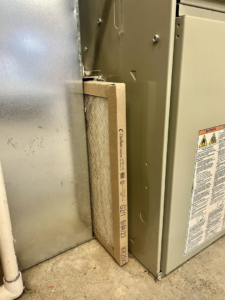 A new HVAC air filter being installed into a furnace or air handler unit by Four Season Heating & Cooling in Saint Joseph, MO.