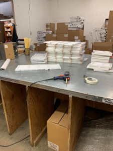 An HVAC air filter production and packaging area at Sierra Filtration Products, Inc. in Reno, NV, showing filters on a workbench.