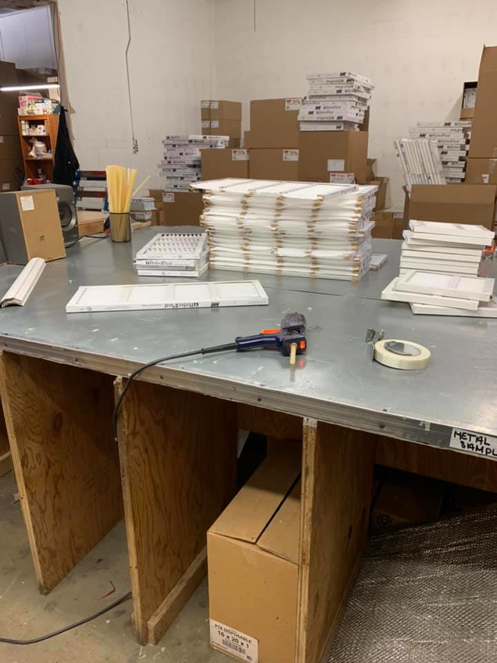An HVAC air filter production and packaging area at Sierra Filtration Products, Inc. in Reno, NV, showing filters on a workbench.