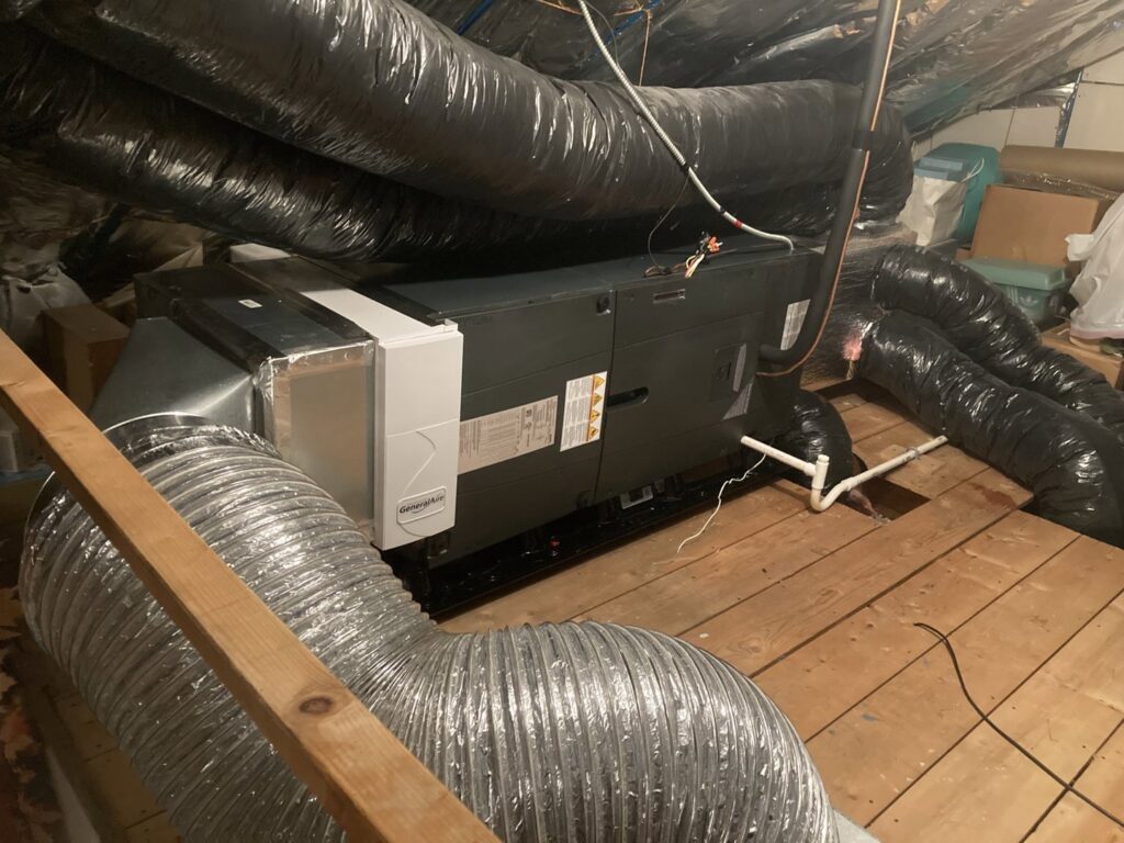 An HVAC air handler and ductwork installation in a utility space by Freedom Air Mechanical Contractors LLC in Everett, MA.