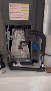 An indoor HVAC air handler unit with exposed coils undergoing service by Air Support Cooling and Heating, LLC in Tampa, FL