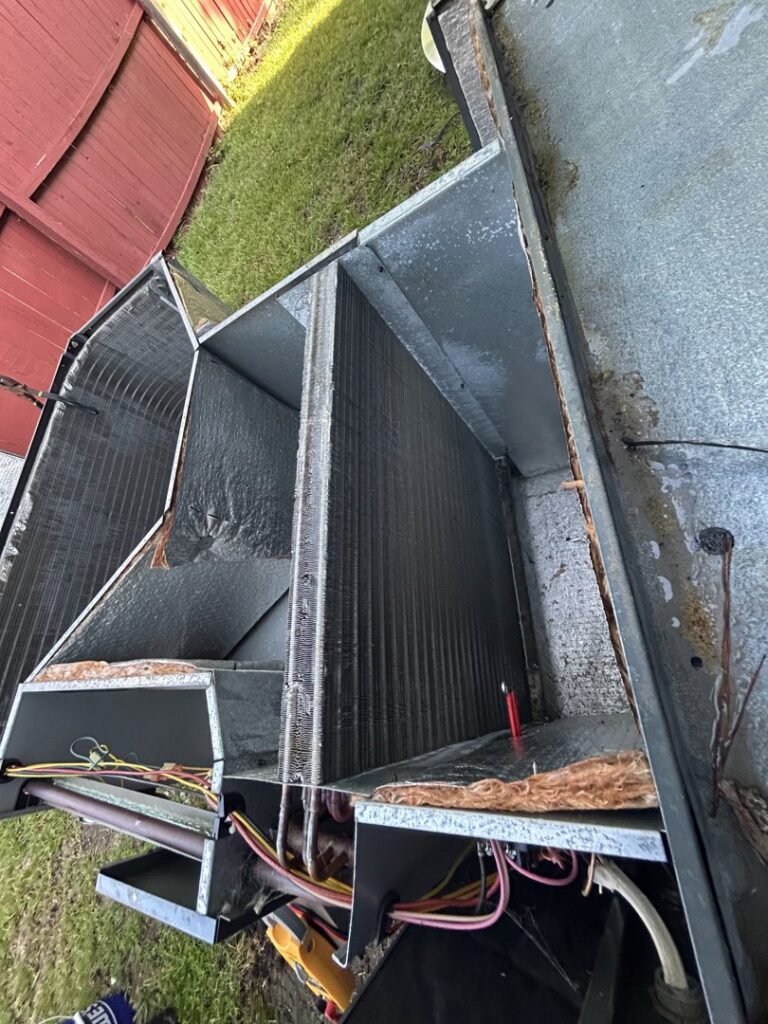 Inside an HVAC air handler showing the evaporator coil and electrical wiring, serviced by Krantz Kooling & Heating in West Columbia, SC