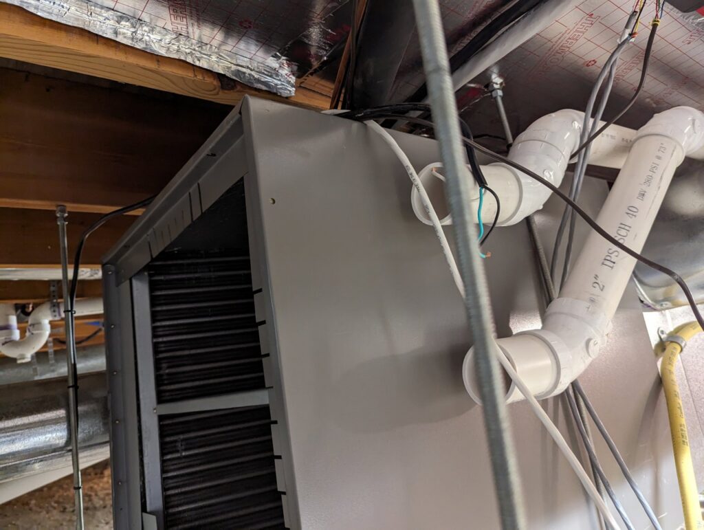 Interior view of HVAC air handler coils and ductwork connections by Central Heating & Air Conditioning in Billings, MT