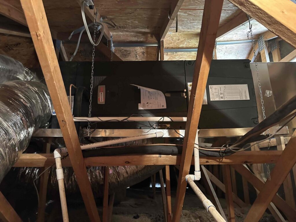 An HVAC air handler unit and ductwork installed in an attic by AZ Perfect Comfort in Phoenix, AZ.