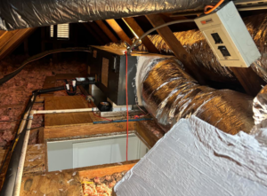 An HVAC air handler unit and ductwork installed in an attic by Greene Mechanical in Holly Springs, GA.