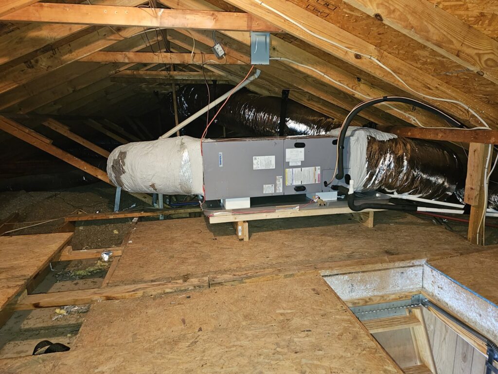 An HVAC air handler unit and insulated ductwork installed in an attic by Advance Heating & Air, Inc. in Sumter, SC.