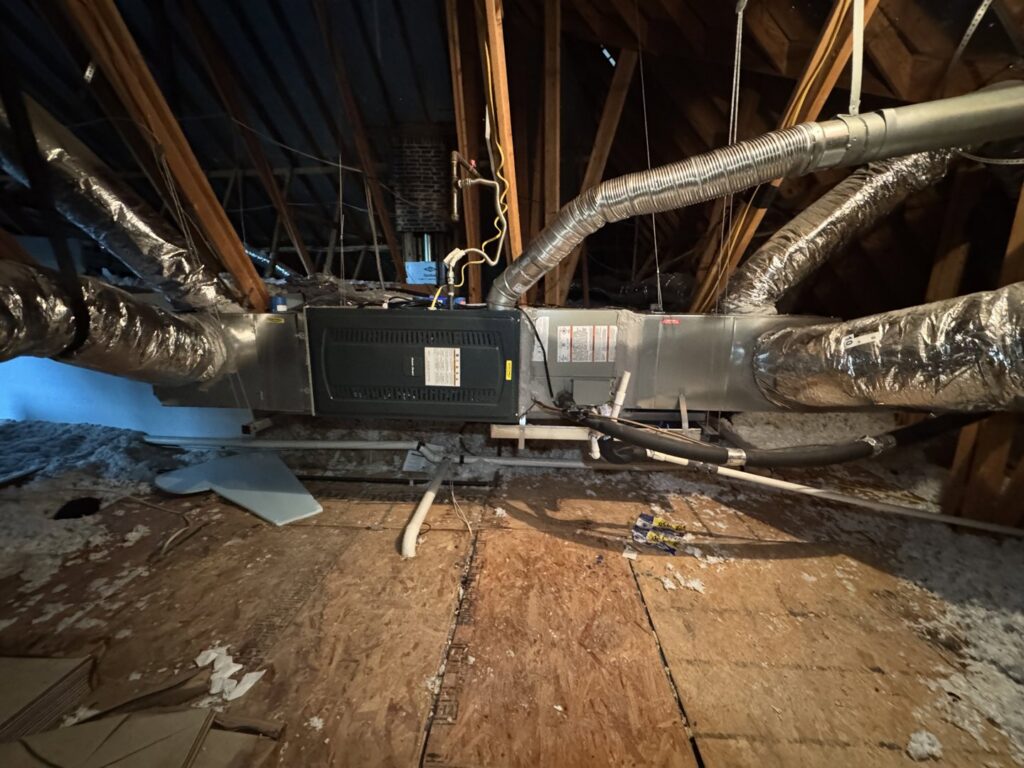 An HVAC air handler and ductwork installation in an attic by Harlen Johnson Heating & Air in Dallas, TX.