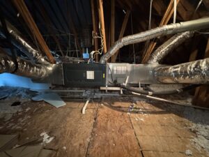 An HVAC air handler and ductwork installation in an attic by Harlen Johnson Heating & Air in Dallas, TX.