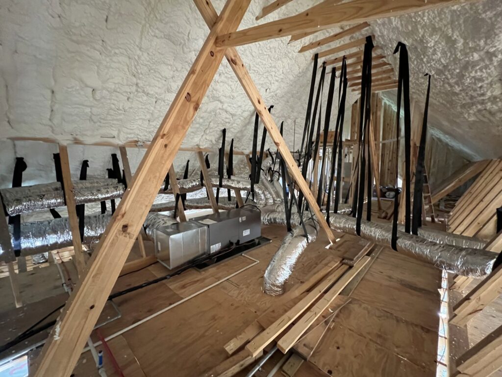 An HVAC air handler unit and extensive ductwork installation in an attic with spray foam insulation by Moreau's Heating & AC in Lake Charles, LA.