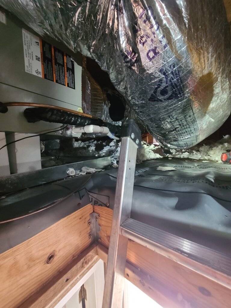 View into an attic showing an HVAC air handler and ductwork installation by Rivertech Heating & Air Conditioning in Chattanooga, TN.