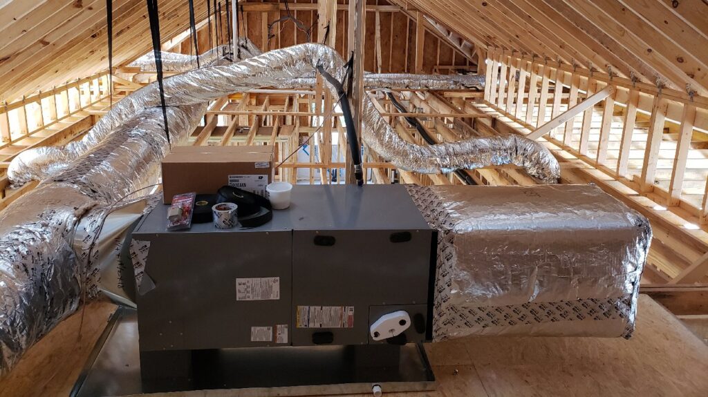 An HVAC air handler unit and ductwork being installed in an attic by Hutcheson Mechanical & Exteriors in Columbia, SC.