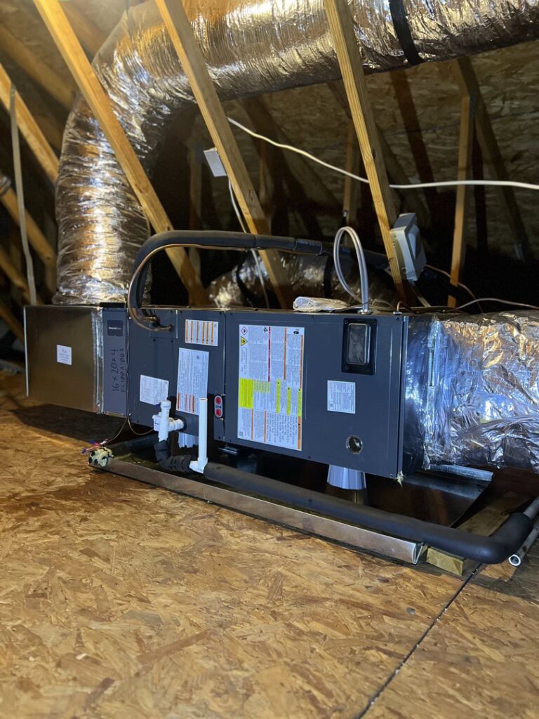 An HVAC air handler unit and ductwork installed in an attic by Brand Air Heating and Cooling LLC in Wilmington, NC.