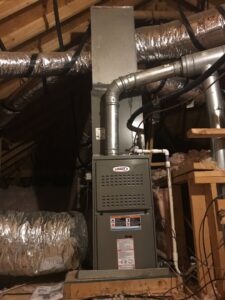 An indoor HVAC air handler unit with ductwork installed in an attic by Gouker's Best Air in Franklin, TN.