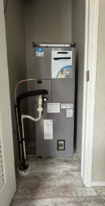 An indoor HVAC air handler unit installed in a closet by Nashville Heating & Air in Gallatin, TN