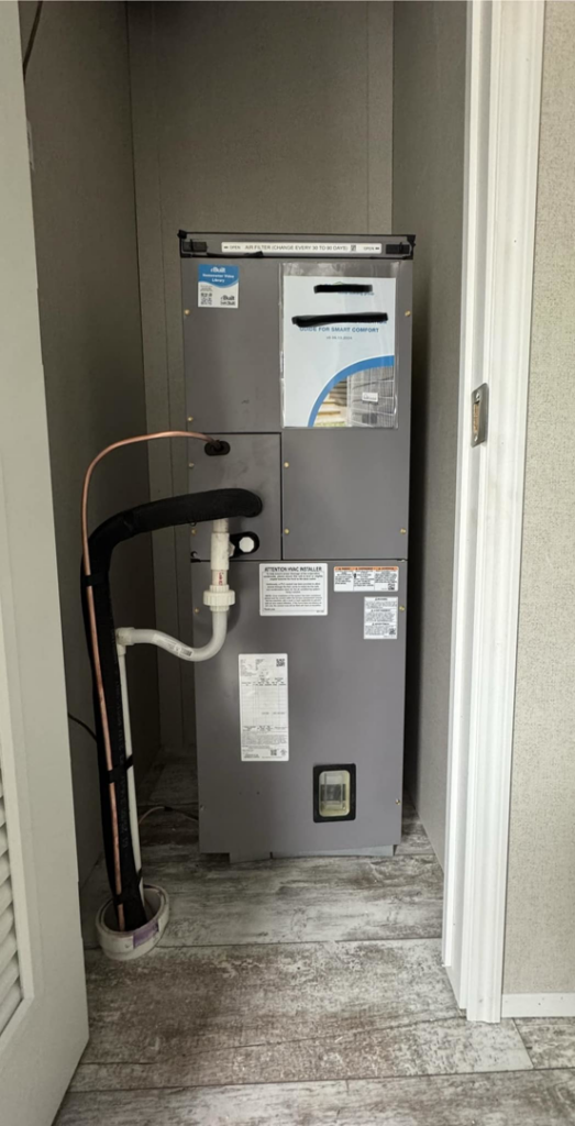 An indoor HVAC air handler unit installed in a closet by Nashville Heating & Air in Gallatin, TN