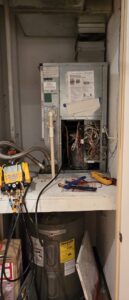 An HVAC technician's tools and an open air handler unit during a repair by By the Bay Mechanical in Prince Frederick, MD