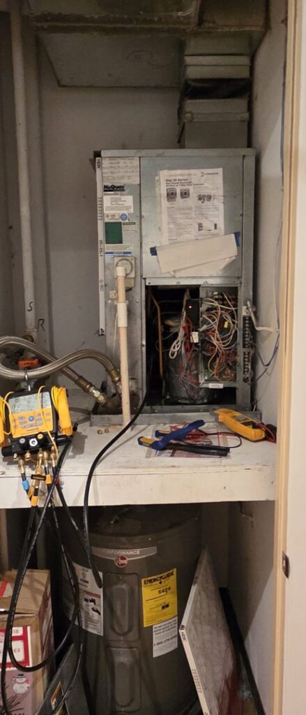 An HVAC technician's tools and an open air handler unit during a repair by By the Bay Mechanical in Prince Frederick, MD