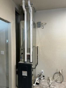 Installed HVAC air handler and ductwork system against a finished wall by ALC Universal in Sheridan, WY.