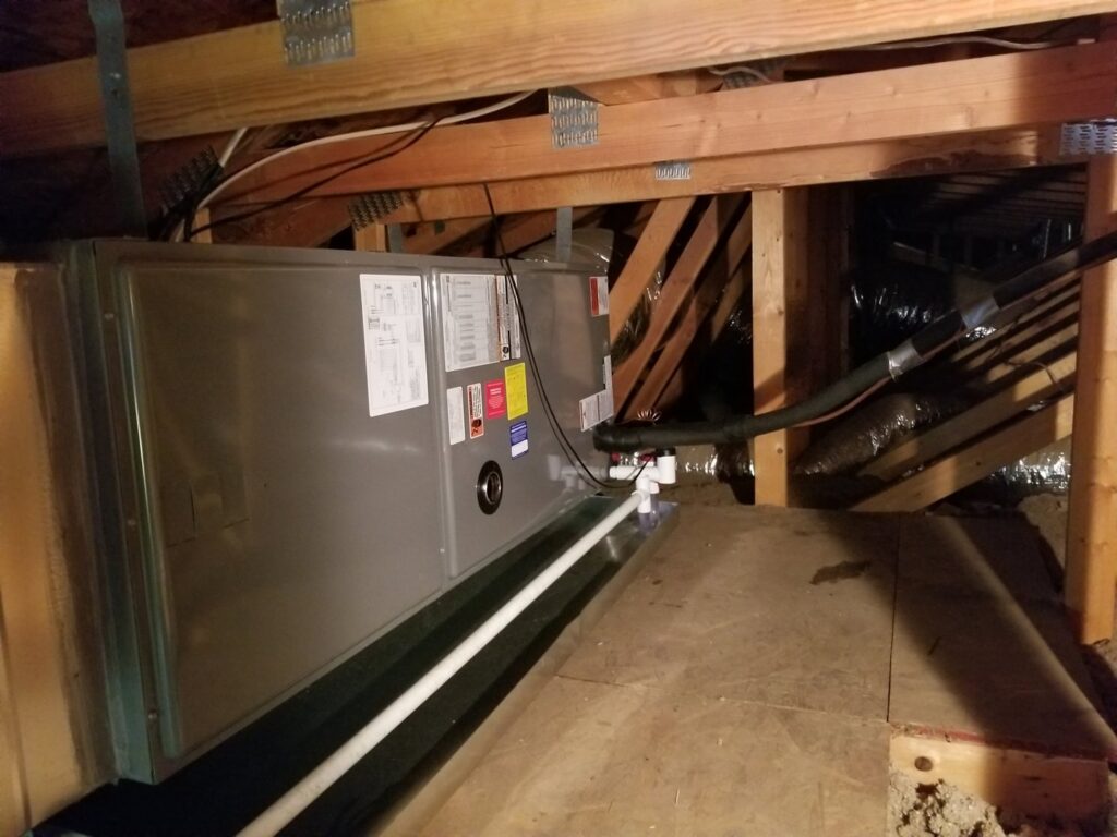 An HVAC air handler unit installed in an attic space, part of a system by Kade Mechanical in Phoenix, AZ.