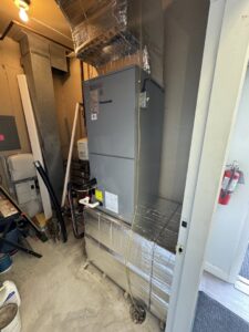 An HVAC air handler unit installed in a utility room by Comfort Systems and Solutions in Coventry, RI