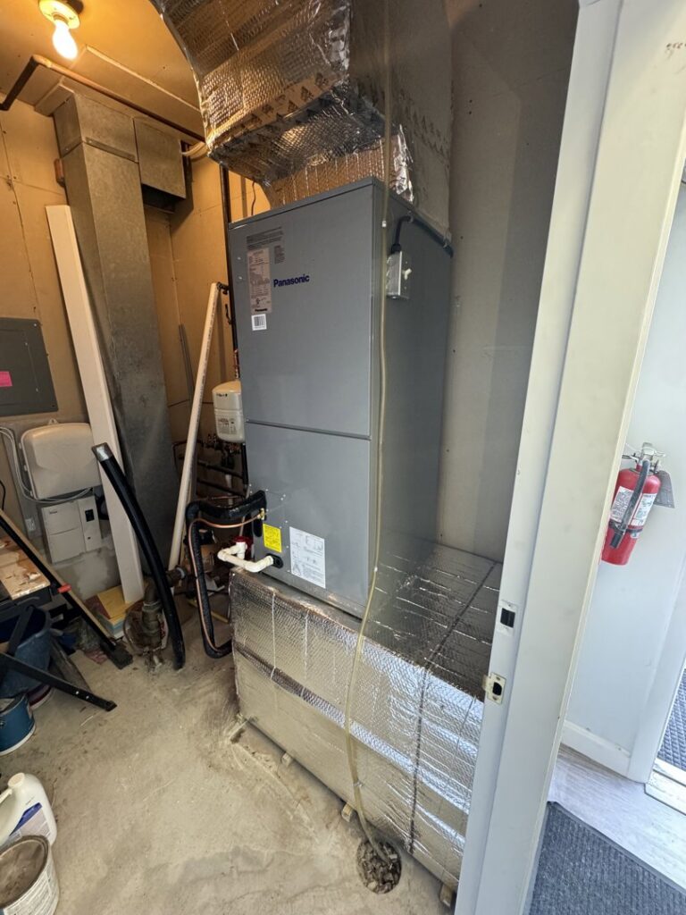 An HVAC air handler unit installed in a utility room by Comfort Systems and Solutions in Coventry, RI