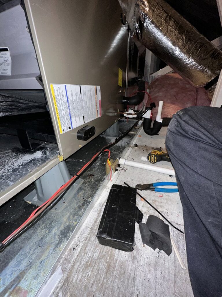 The base of an HVAC air handler with visible wiring and tools, indicating a repair or installation by Love HVAC LLC in Bluffton, SC.