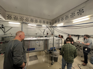 HVAC professionals testing an air handling unit with multiple fans at Buckley Associates, Inc. in Hanover, MA