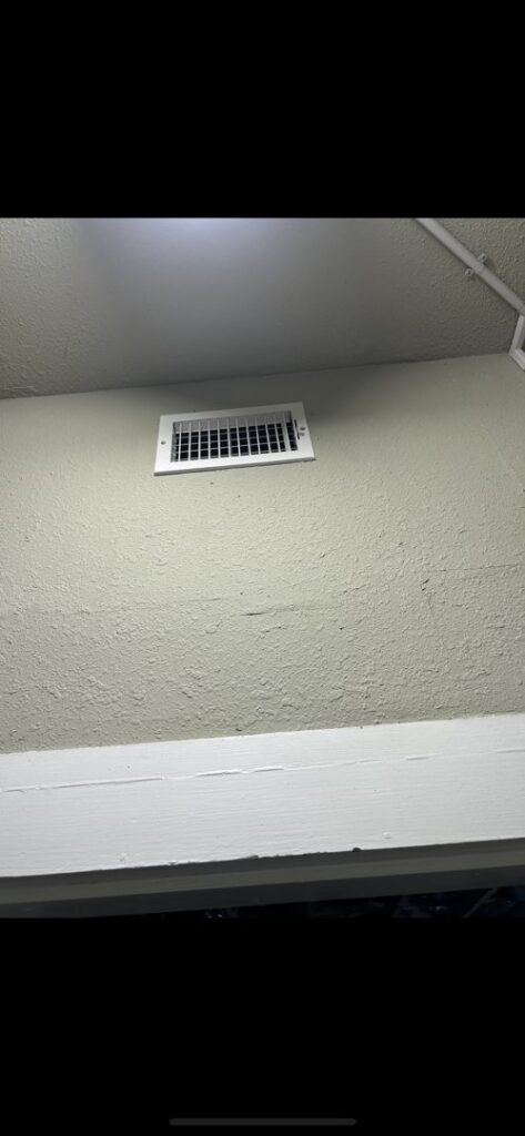 A white HVAC air vent or register installed on a wall, part of a system by Air Advisors of Louisiana in Shreveport, LA.