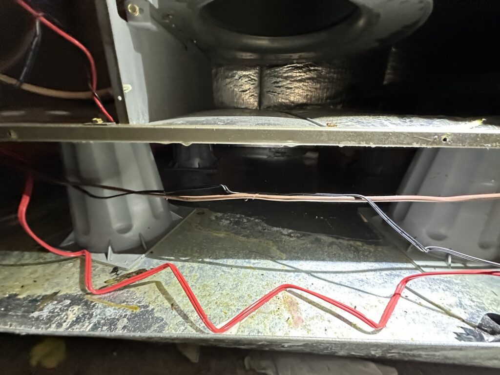 The interior of an HVAC unit showing the blower fan, likely undergoing cleaning or maintenance by Love HVAC LLC in Bluffton, SC.