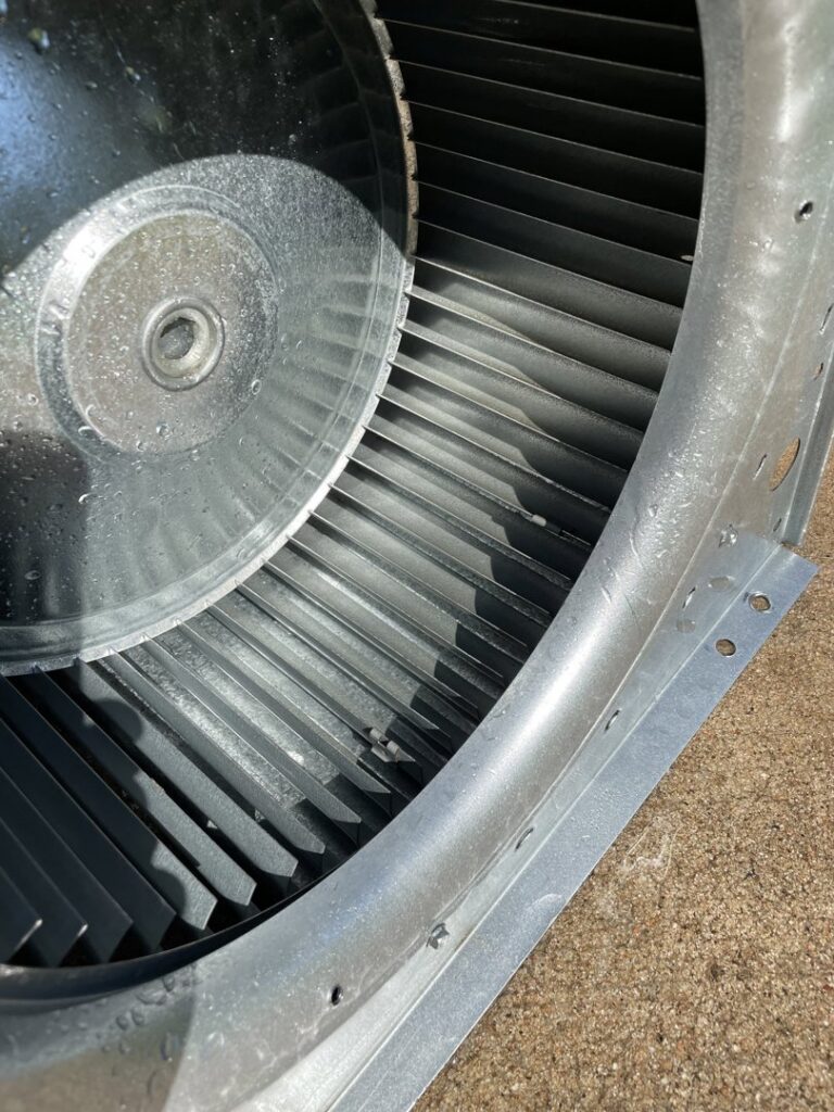 A close-up view of an HVAC blower fan component, ready for inspection or cleaning by Fix It Now Heating and Cooling in Thornton, CO