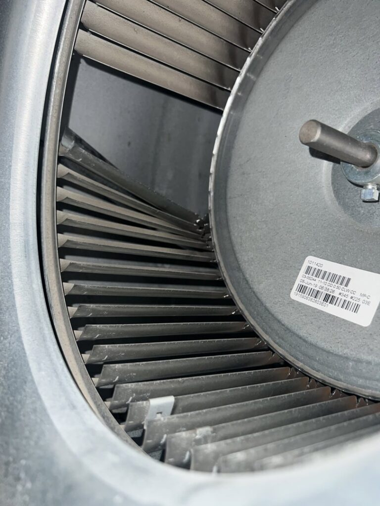 A close-up view of an HVAC blower fan inside a unit, inspected by 4-BIS Solutions HVAC and Home Maintenance in Columbia, MO.