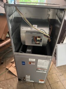 An indoor HVAC air handler with its cover removed, showing the blower fan during an inspection by Southern Climate Pros in Jasper, AL.