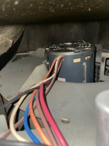 An internal view of an HVAC blower motor with multiple wires, indicating a detailed inspection or service by DeltaCool in Jonesboro, AR.