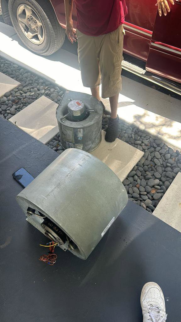 HVAC blower motor replacement parts on the ground during a service by QUICK AIR USA in Orlando, FL.