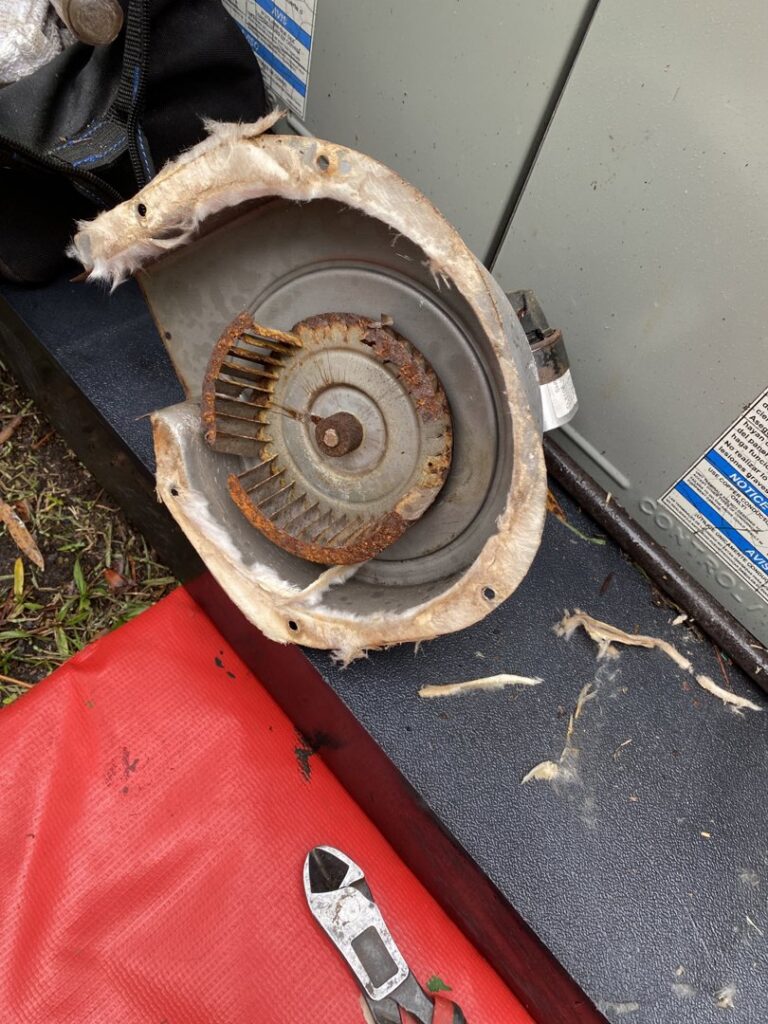 A rusted HVAC blower wheel removed for replacement during a service by Reasonable Air, LLC in Summerville, SC.