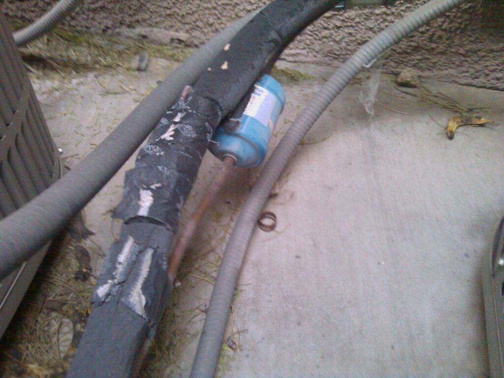 A red gas tank with a gauge, used for brazing during HVAC repair by J AND J HVAC L.L.C in Mesa, AZ