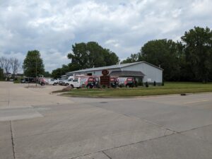 The exterior of Marie Keding Bryant Iowa Heating and Cooling business with multiple service vans parked in Ankeny, IA.