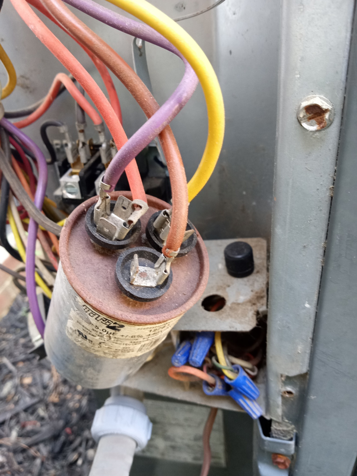 An HVAC capacitor with colorful electrical wiring being serviced by All Seasons Electric Motor and Small Engine Repair in Fayetteville, NC.