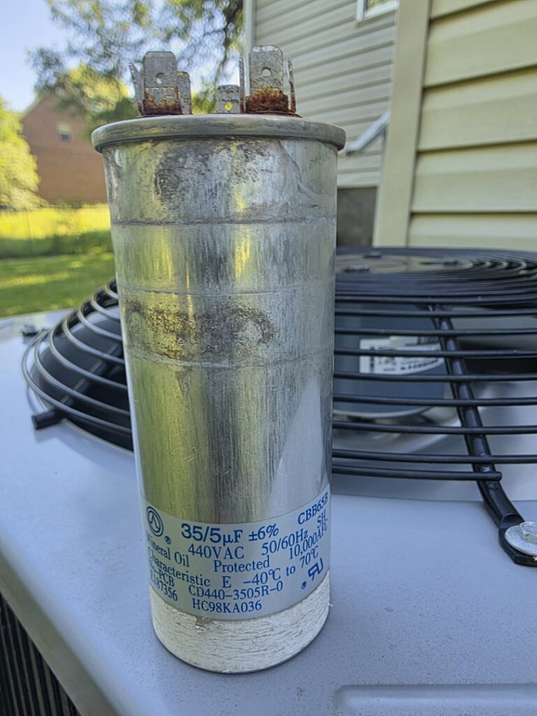 A close-up view of an HVAC capacitor, likely for replacement or inspection, by Bruce Heating & Air in Kennewick, WA.