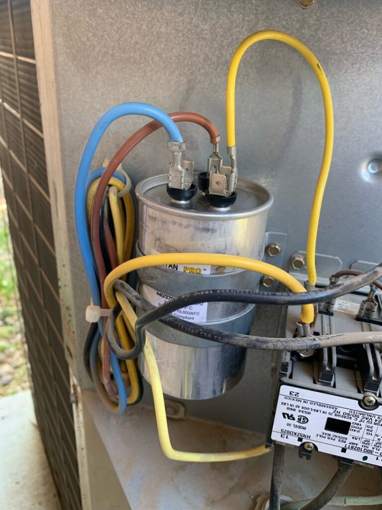Close-up of an HVAC capacitor and wiring during a repair by Dakine Heating & Cooling, LLC in Las Vegas, NV.