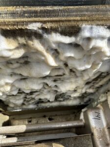 A dirty HVAC coil being cleaned with foam by 32 Degrees Heating and Air Conditioning in Las Vegas, NV